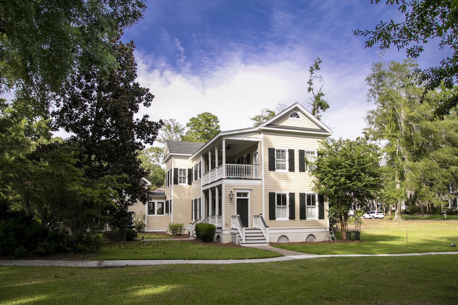 Two-story Southern-style house with covered porches, green shutters, and a manicured lawn—ideal example of properties assessed during a home inspection in Jacksboro TN